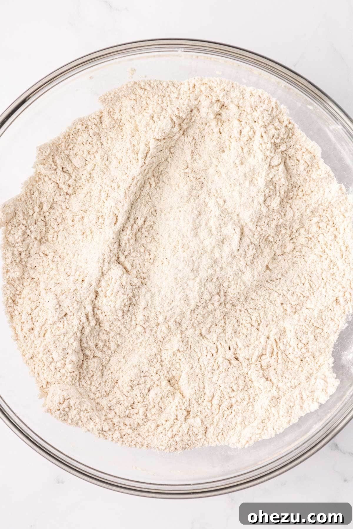 Close-up of a mixing bowl with dry ingredients, now perfectly mixed and uniform, ready for the wet ingredients.