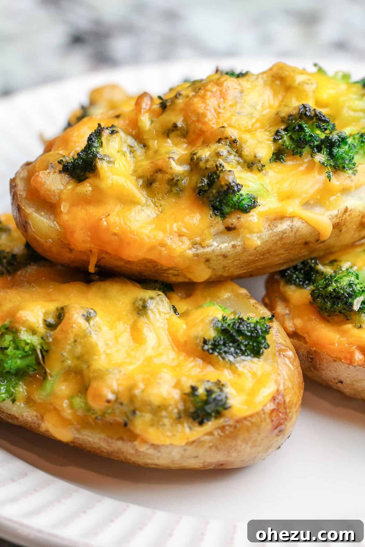 Irresistible Broccoli Cheddar Twice Baked Potatoes 4 Broccoli Cheddar Twice Baked Potatoes arranged on a platter, ready to serve