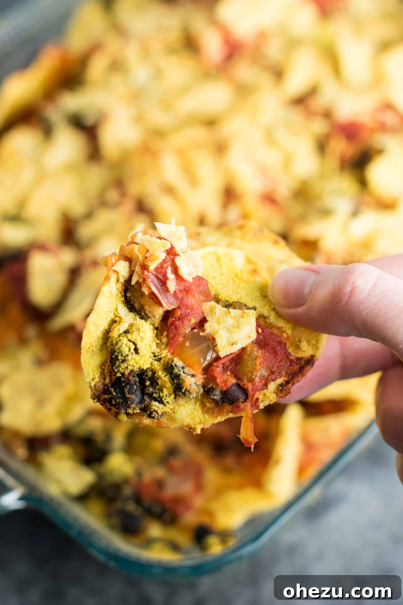 Easy Vegan Taco Bake Recipes - a quick and wholesome plant-based meal perfect for busy weeknights. Features layers of black beans, salsa, and nutritional yeast, baked to crispy perfection with tortilla chips. Topped with fresh lime juice for an extra zing.