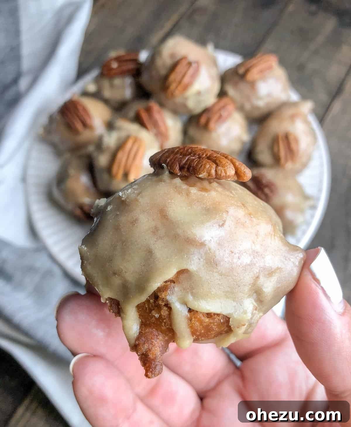 Delicious Pecan Maple Bacon Fritter Bites stacked high on a plate