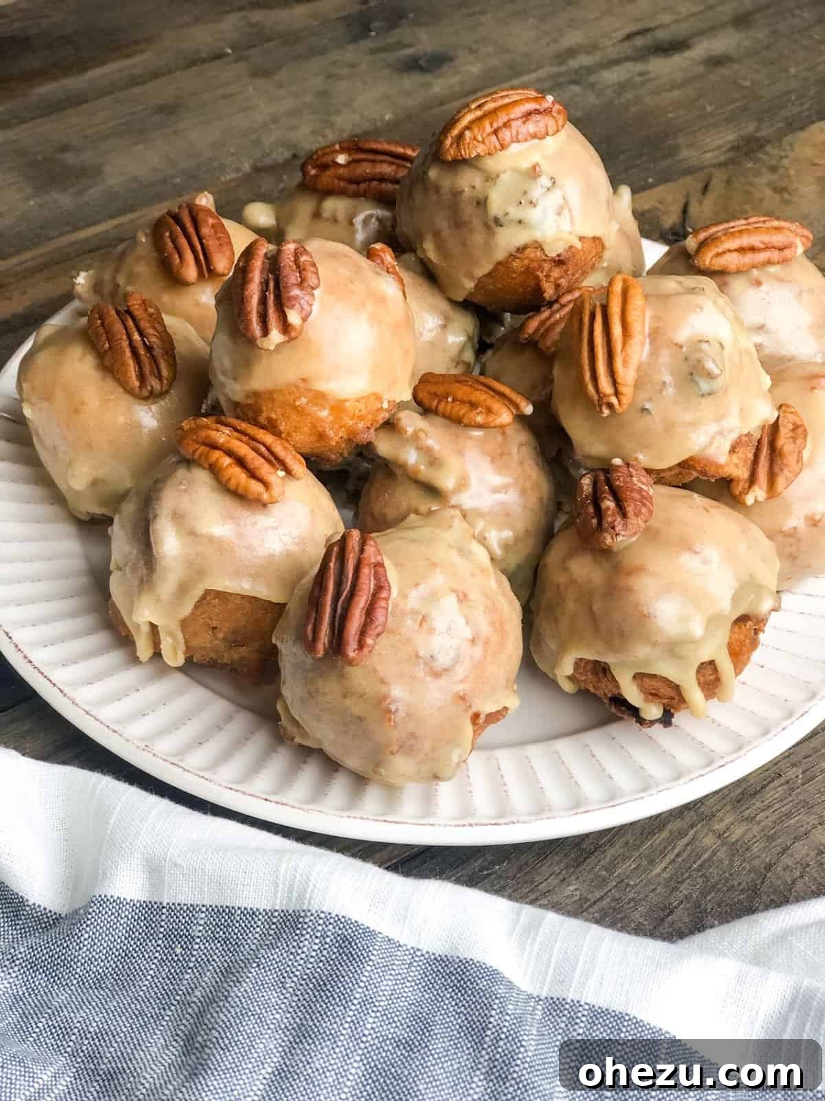 Close-up of golden brown Pecan Maple Bacon Fritter Bites on a cooling rack
