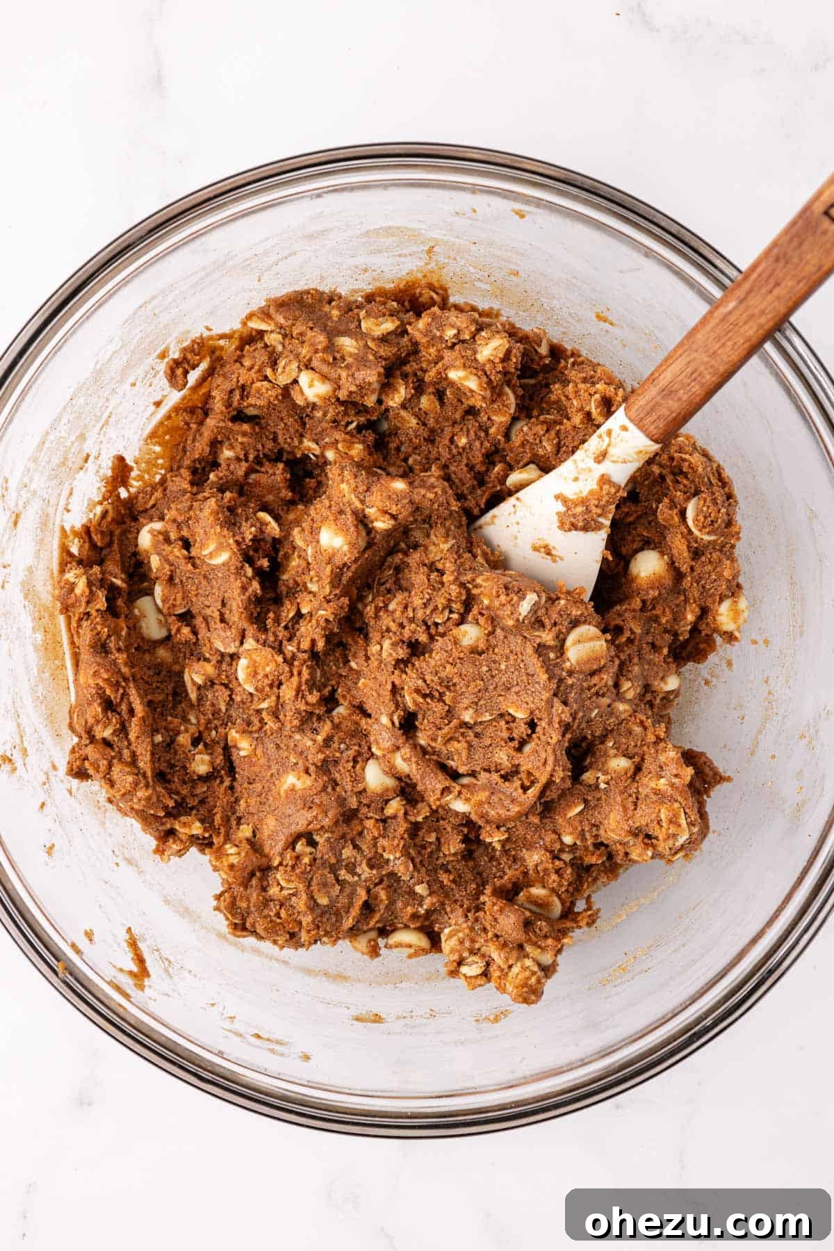Festive Gingerbread Power Bites 6 Mixed energy bite batter in a bowl with a rubber spatula, ready for shaping