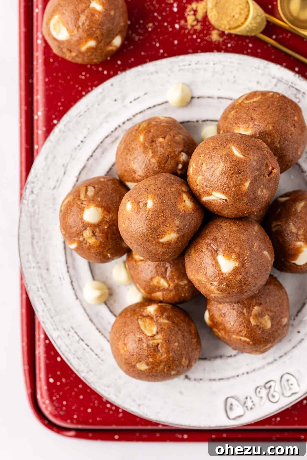 Festive Gingerbread Power Bites 9 Several gingerbread energy bites piled artfully on a festive plate