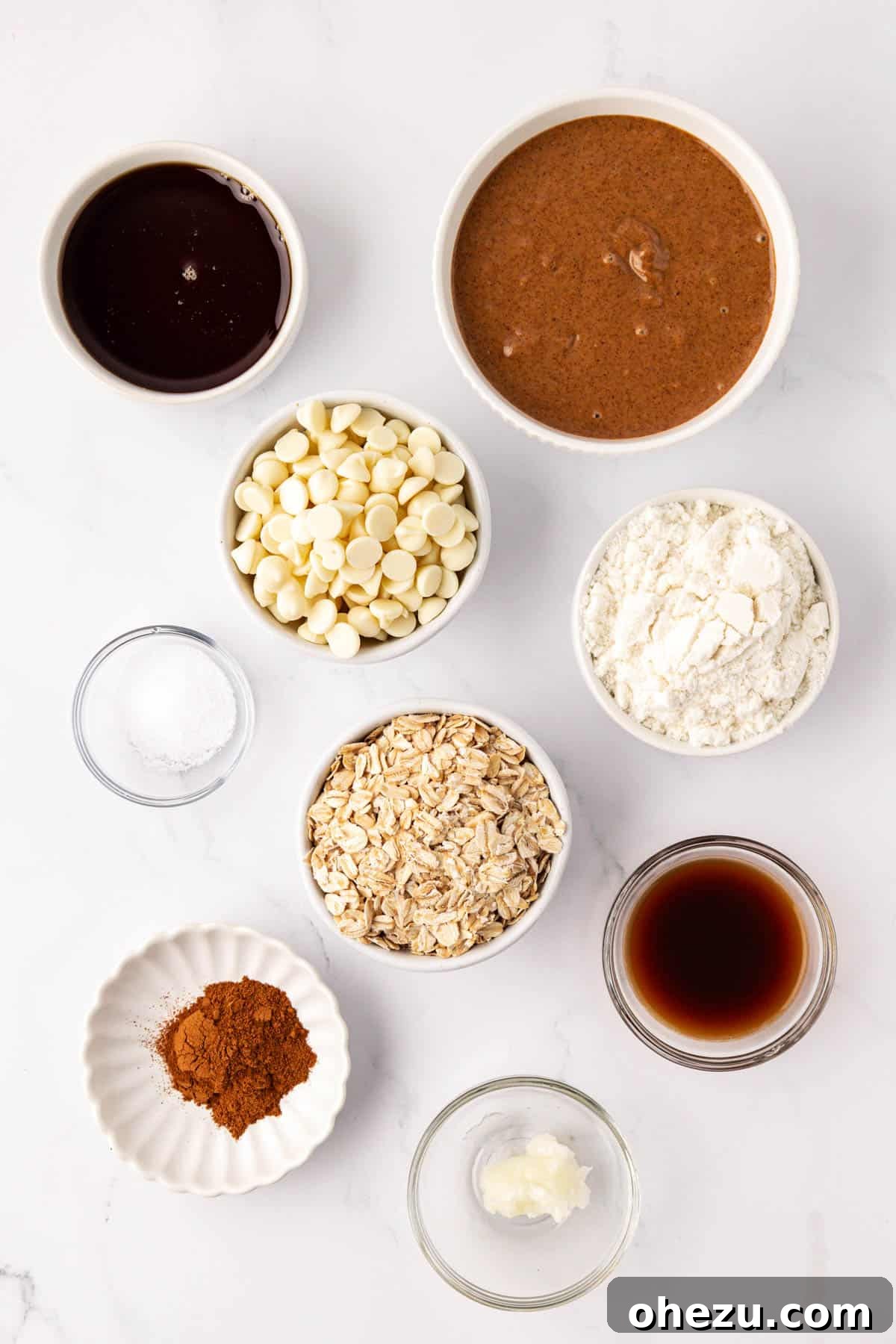 individual bowls displaying the ingredients for cinnamon roll energy bites