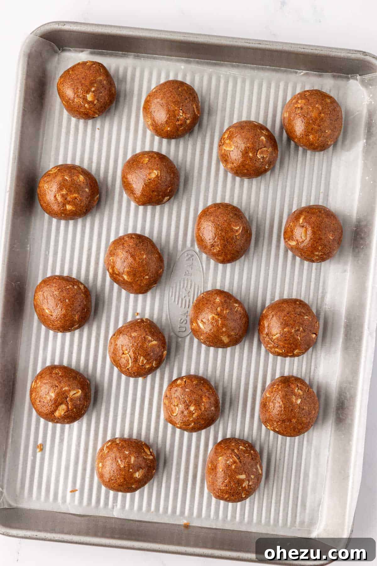 formed energy bites arranged neatly on a baking sheet