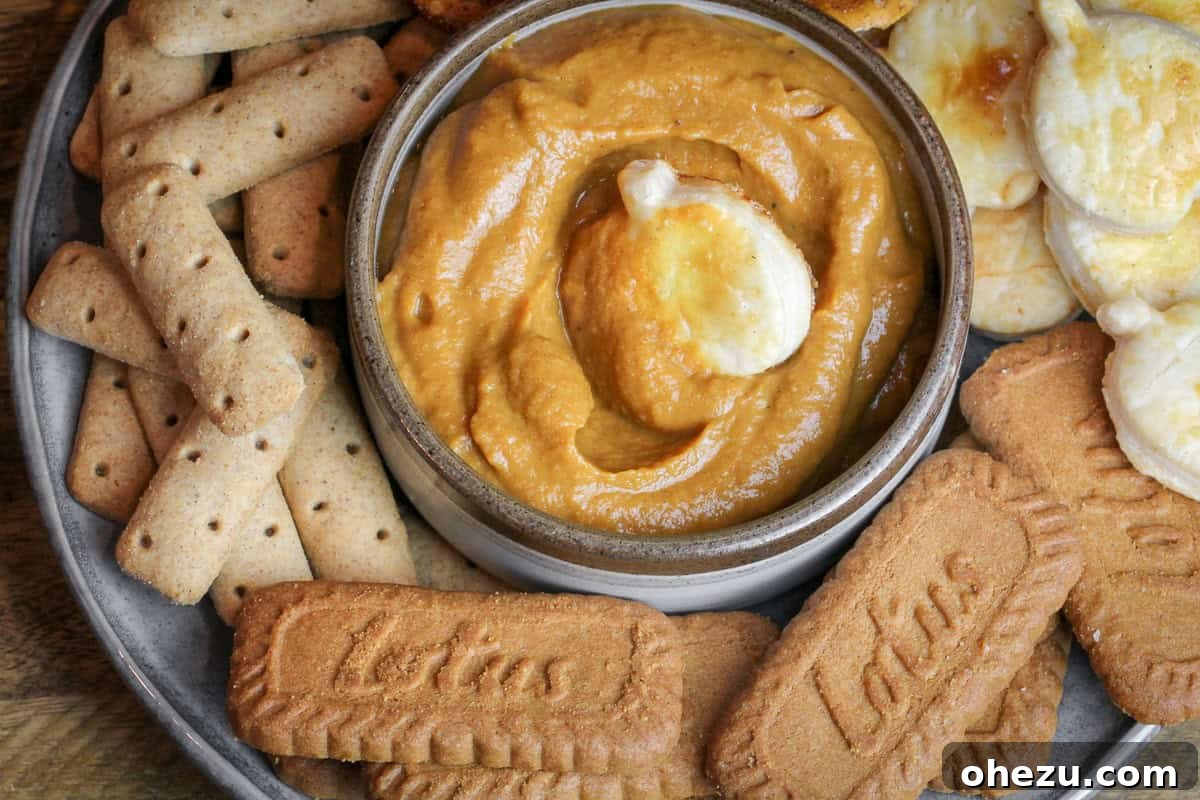 Pumpkin Pie Dessert Hummus served in a bowl with various dippers like cookies and apple slices