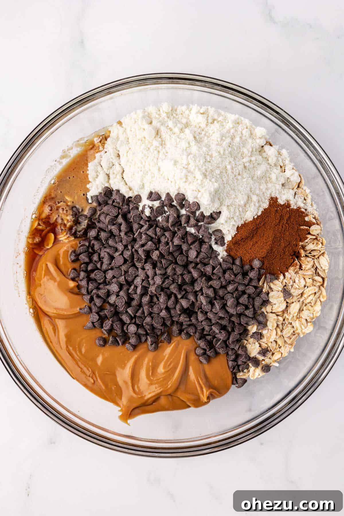 All raw ingredients for energy balls in a mixing bowl before combining.