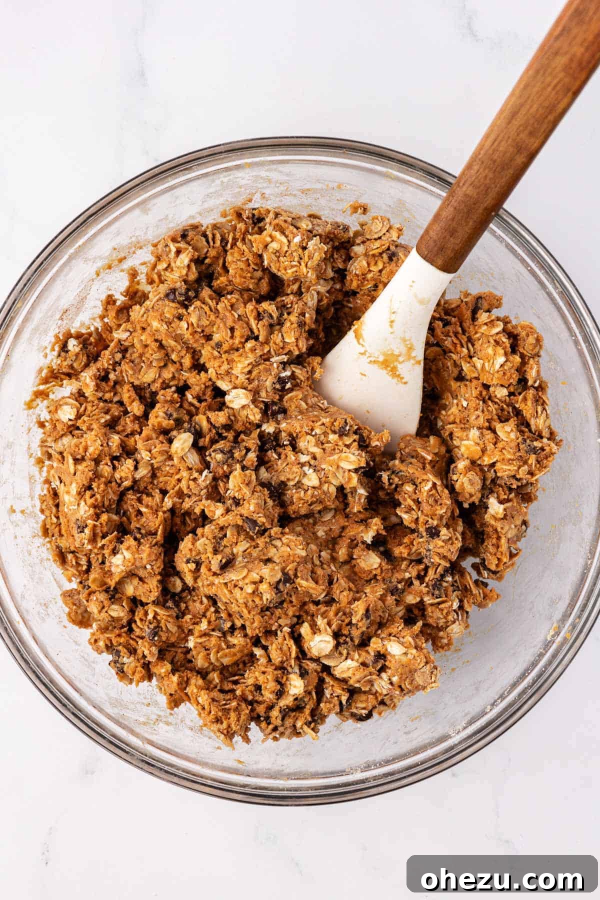 Energy ball batter mixed to a thick consistency in a bowl, ready for scooping.