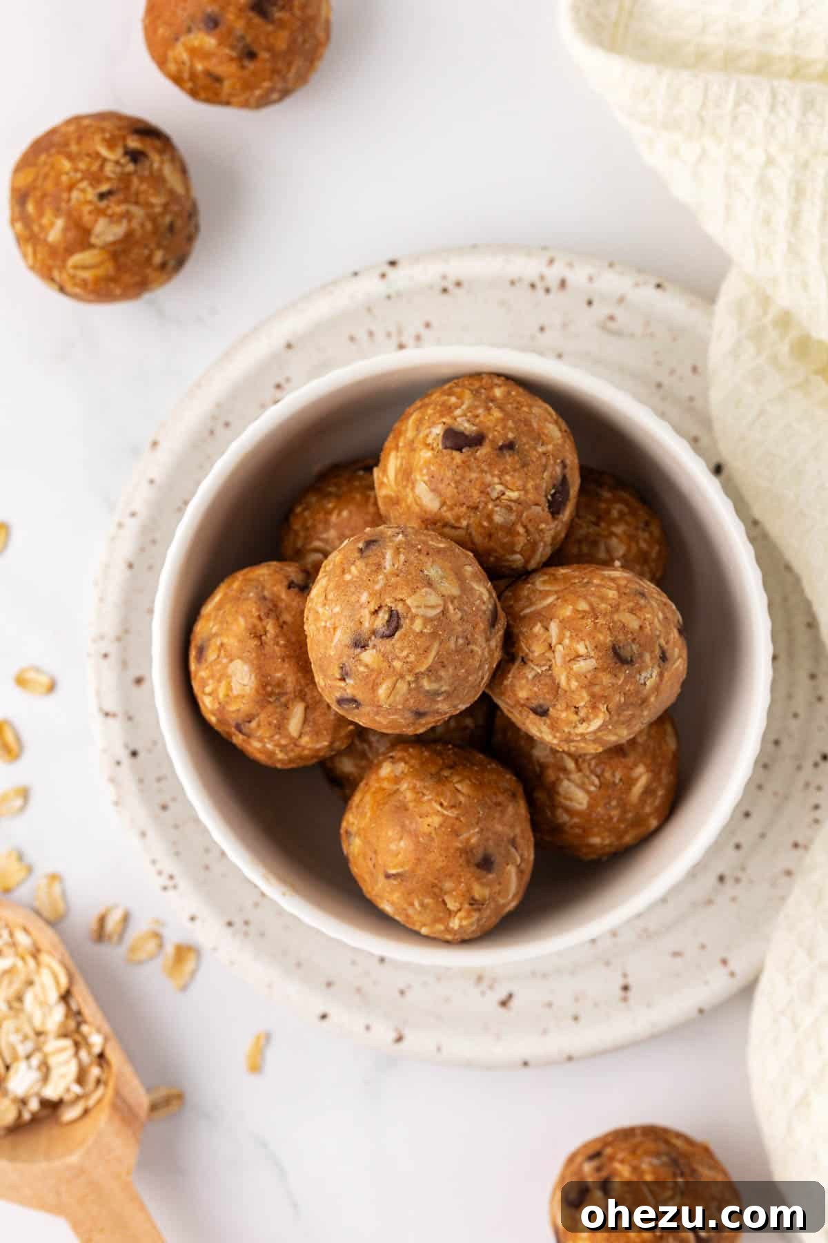 A close-up of a single oatmeal cookie energy ball, showing its appealing texture and readiness to be eaten.
