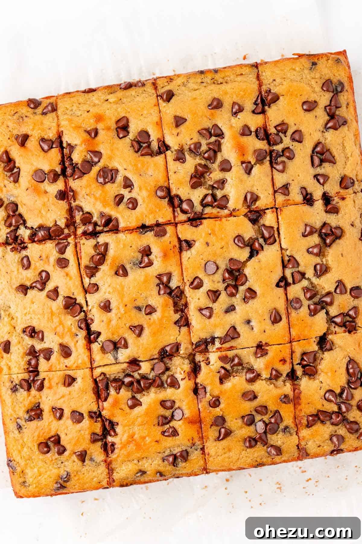 Tangy Greek Yogurt Treat Cake 18 Greek Yogurt Snack Cake perfectly cut into 12 square slices on a cutting board