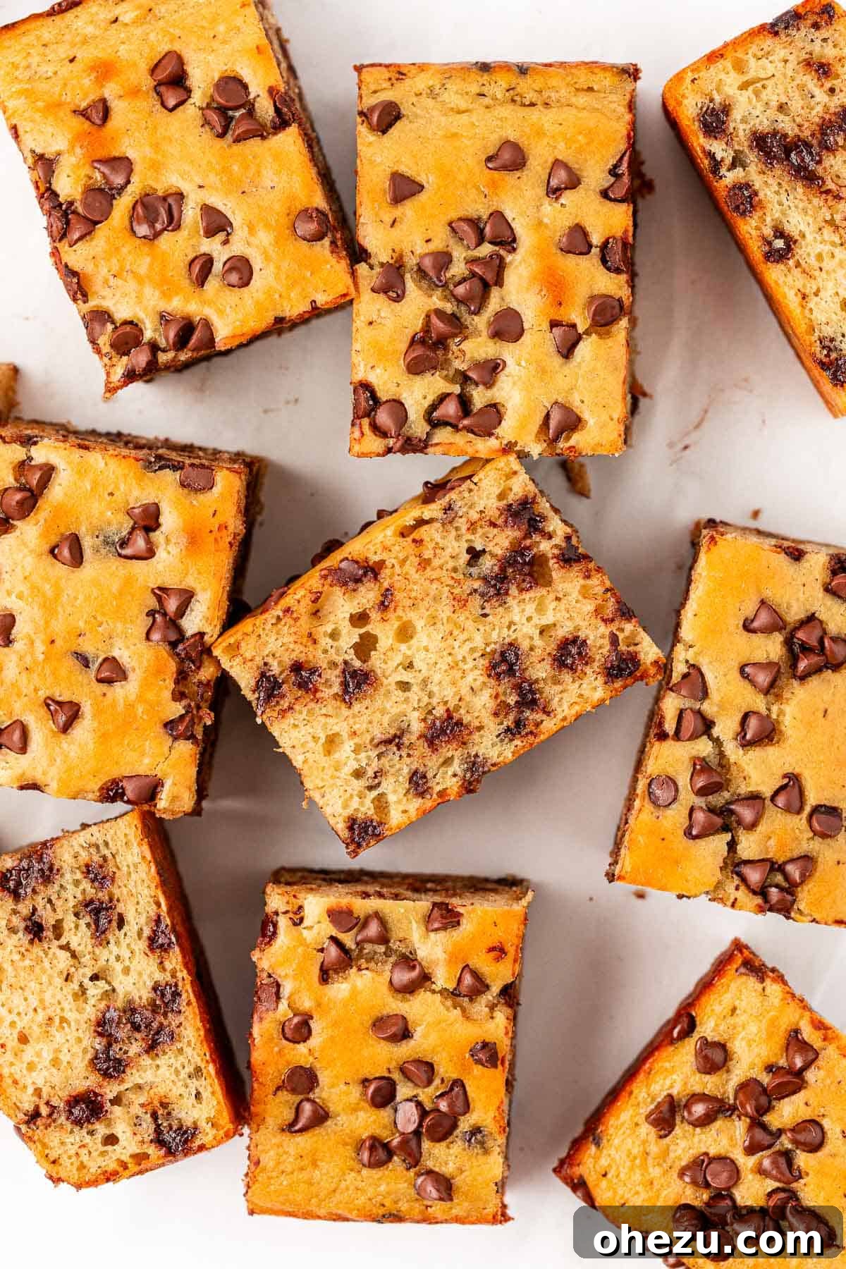 Tangy Greek Yogurt Treat Cake 3 Freshly baked Greek Yogurt Snack Cake, golden brown with melted chocolate chips