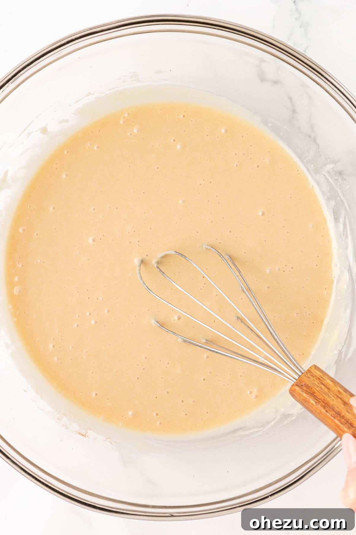 Tangy Greek Yogurt Treat Cake 10 Wet ingredients with eggs fully whisked in, showing a smooth consistency