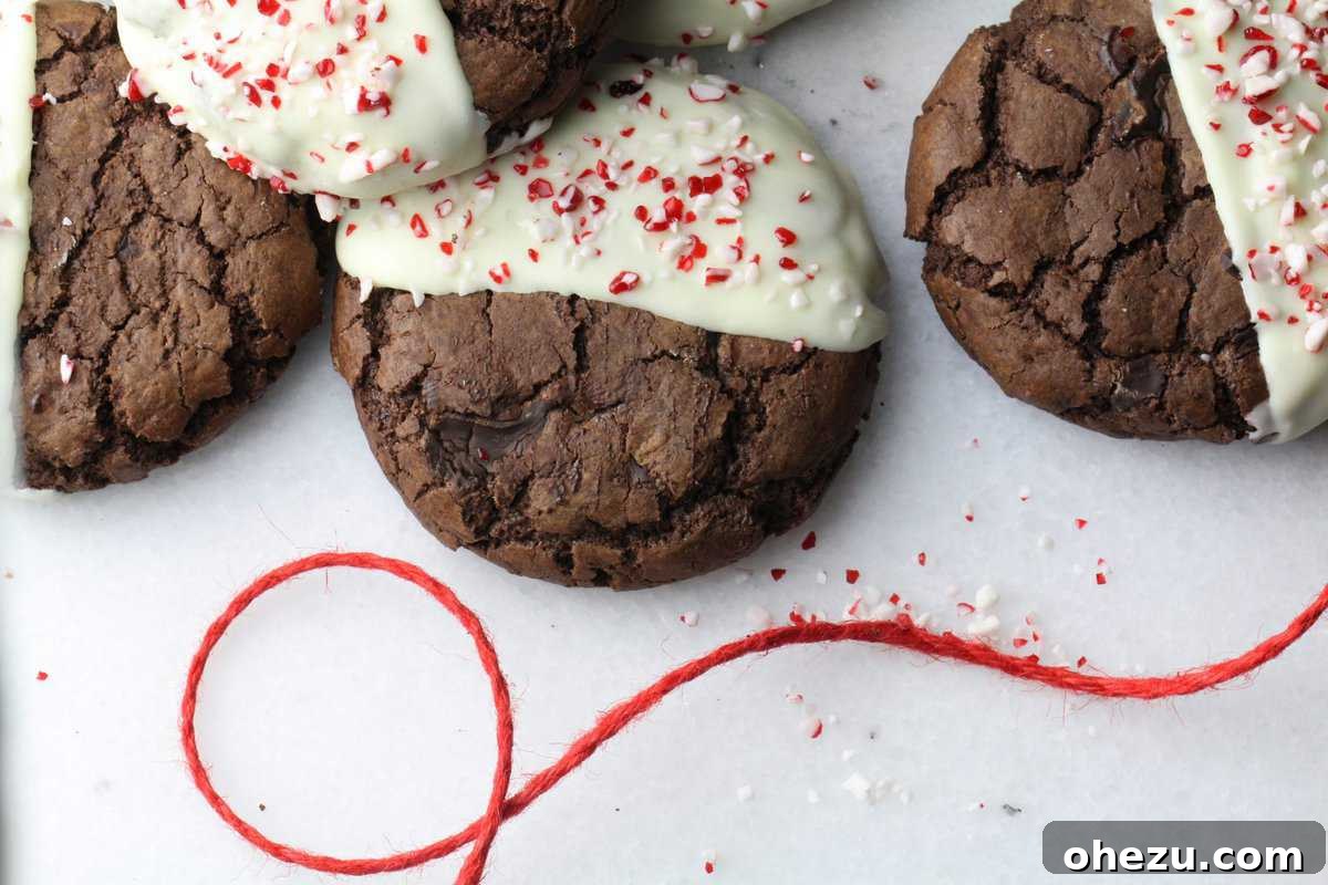 Close-up of a soft-batch triple chocolate peppermint cookie with a glossy white chocolate coating.