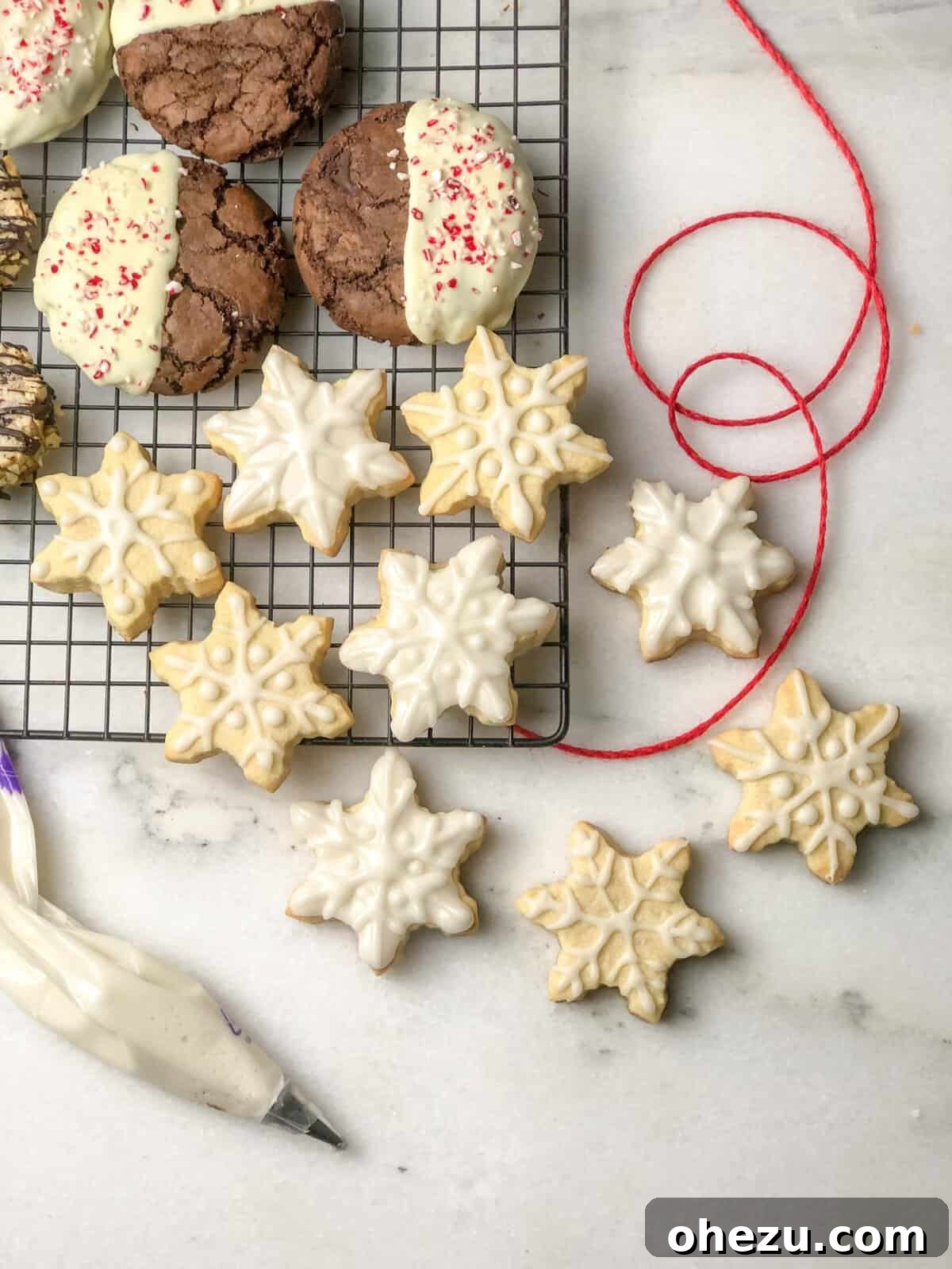 A close-up of a soft-batch triple chocolate peppermint cookie, showcasing its rich, chewy interior and decorative topping.