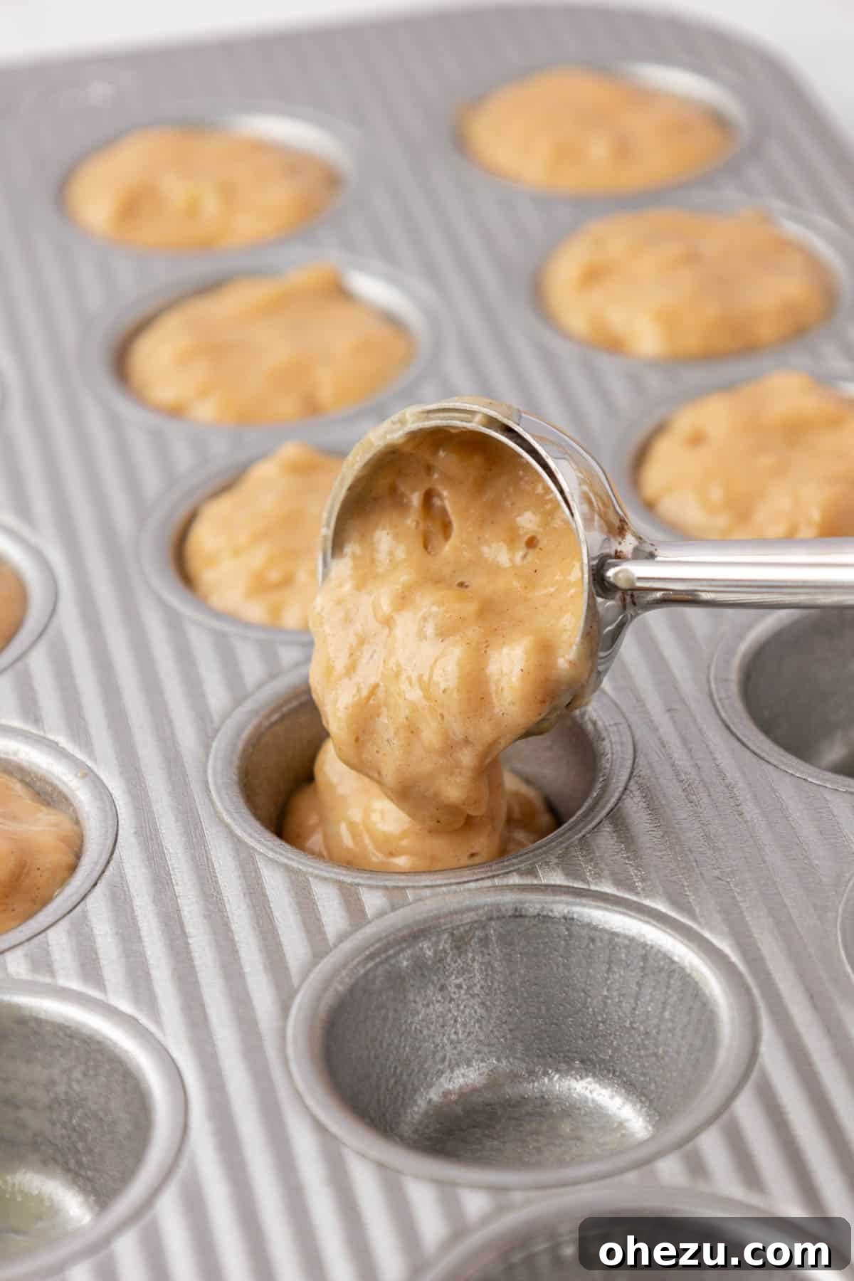 pouring the muffin batter into a mini muffin tin