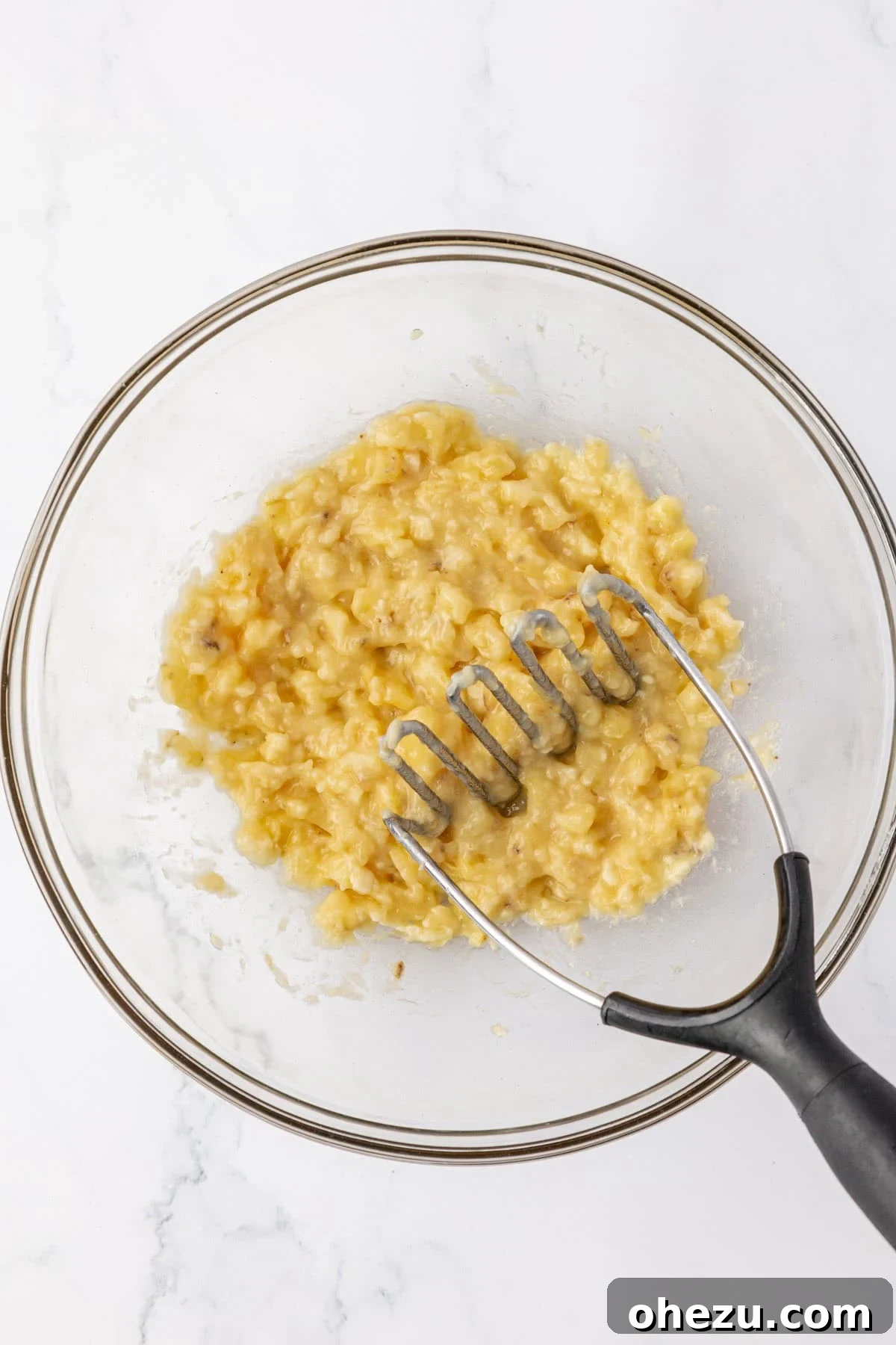 mashed bananas in a mixing bowl