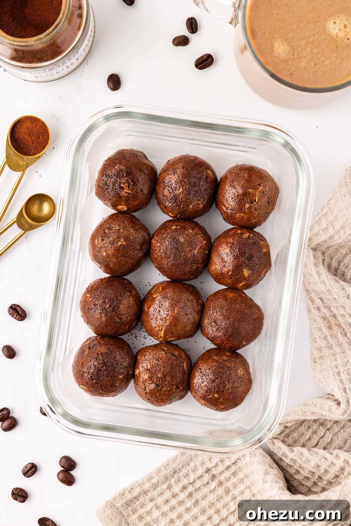 Rich and delicious Espresso Energy Bites arranged on a white surface, showcasing their chocolatey texture.