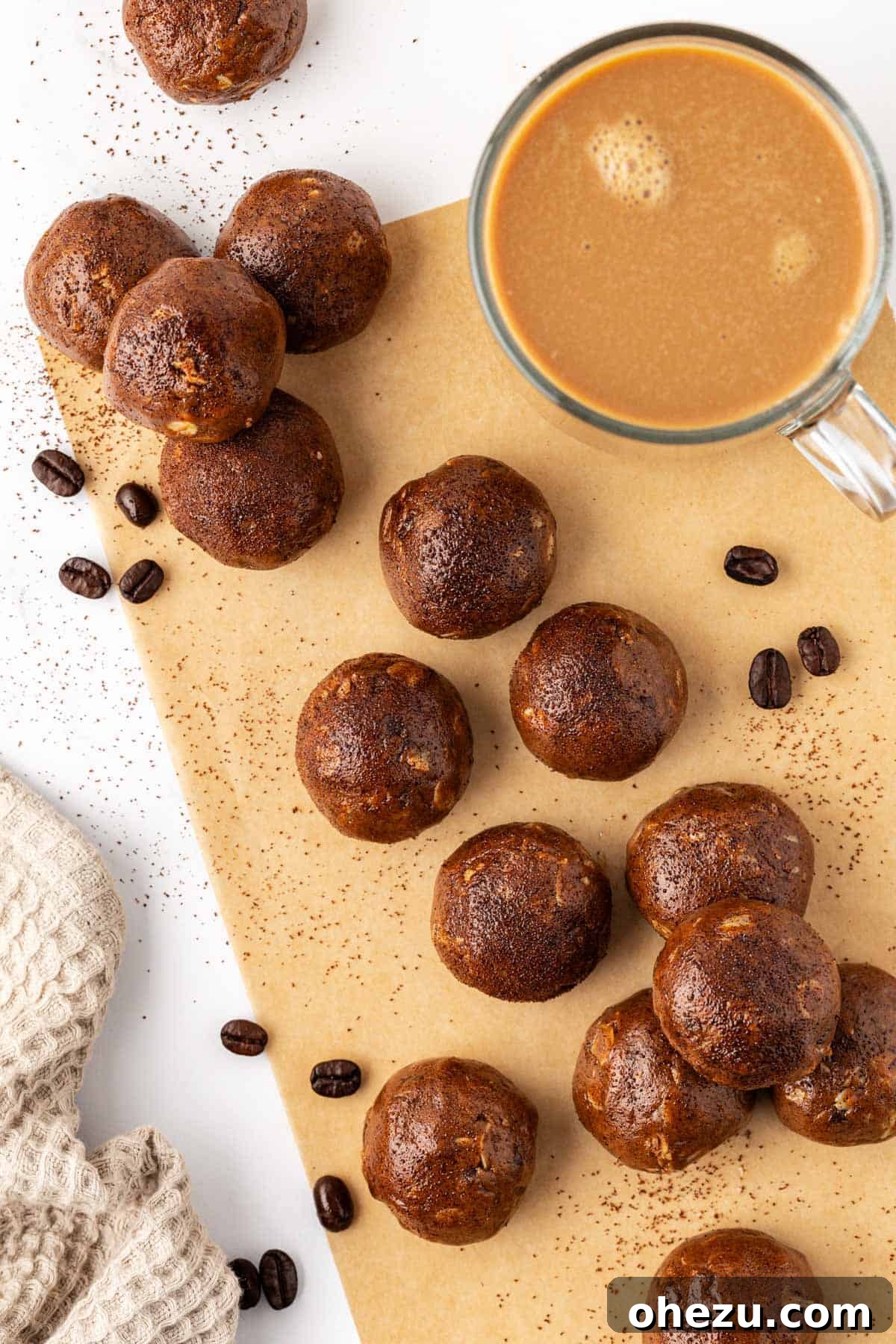 Close-up of freshly prepared Espresso Energy Bites, dusted with espresso powder, on a clean surface.