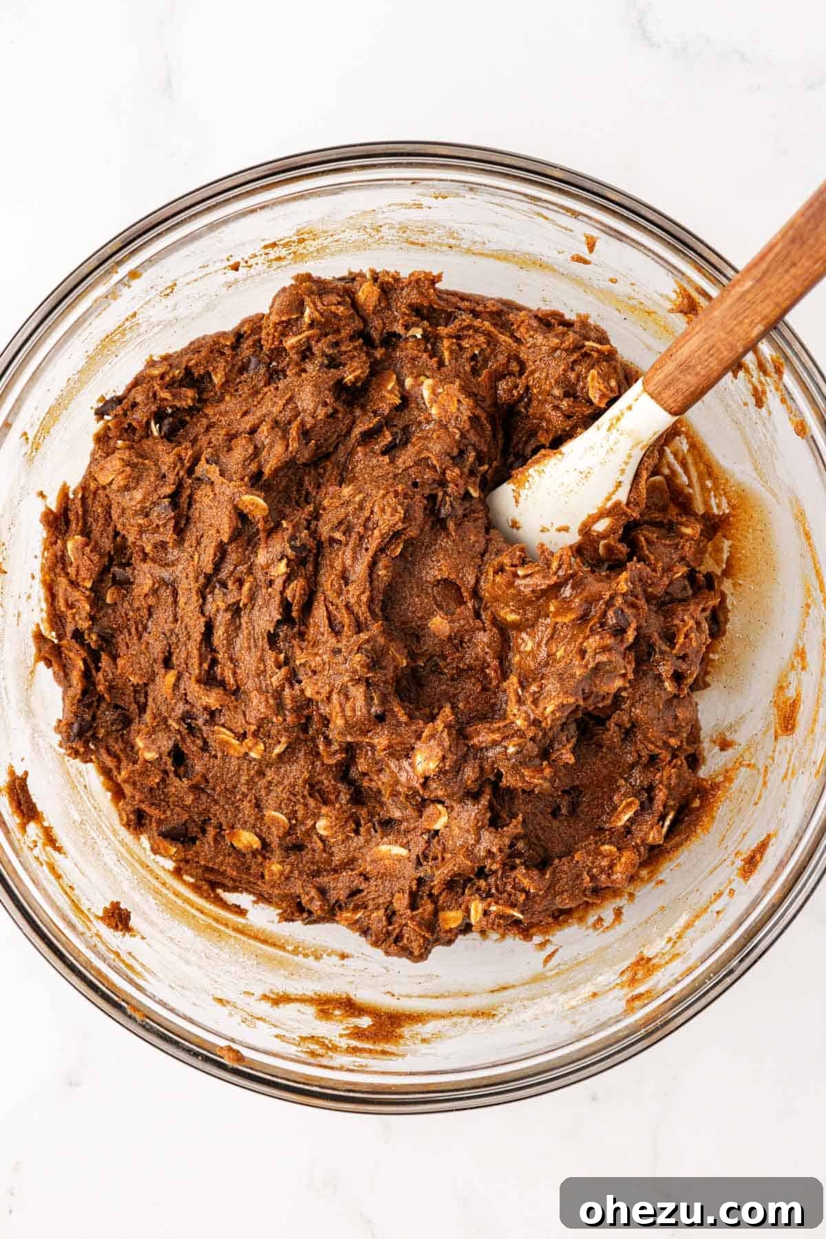Thick, well-mixed espresso energy bite batter in a mixing bowl, ready for scooping.