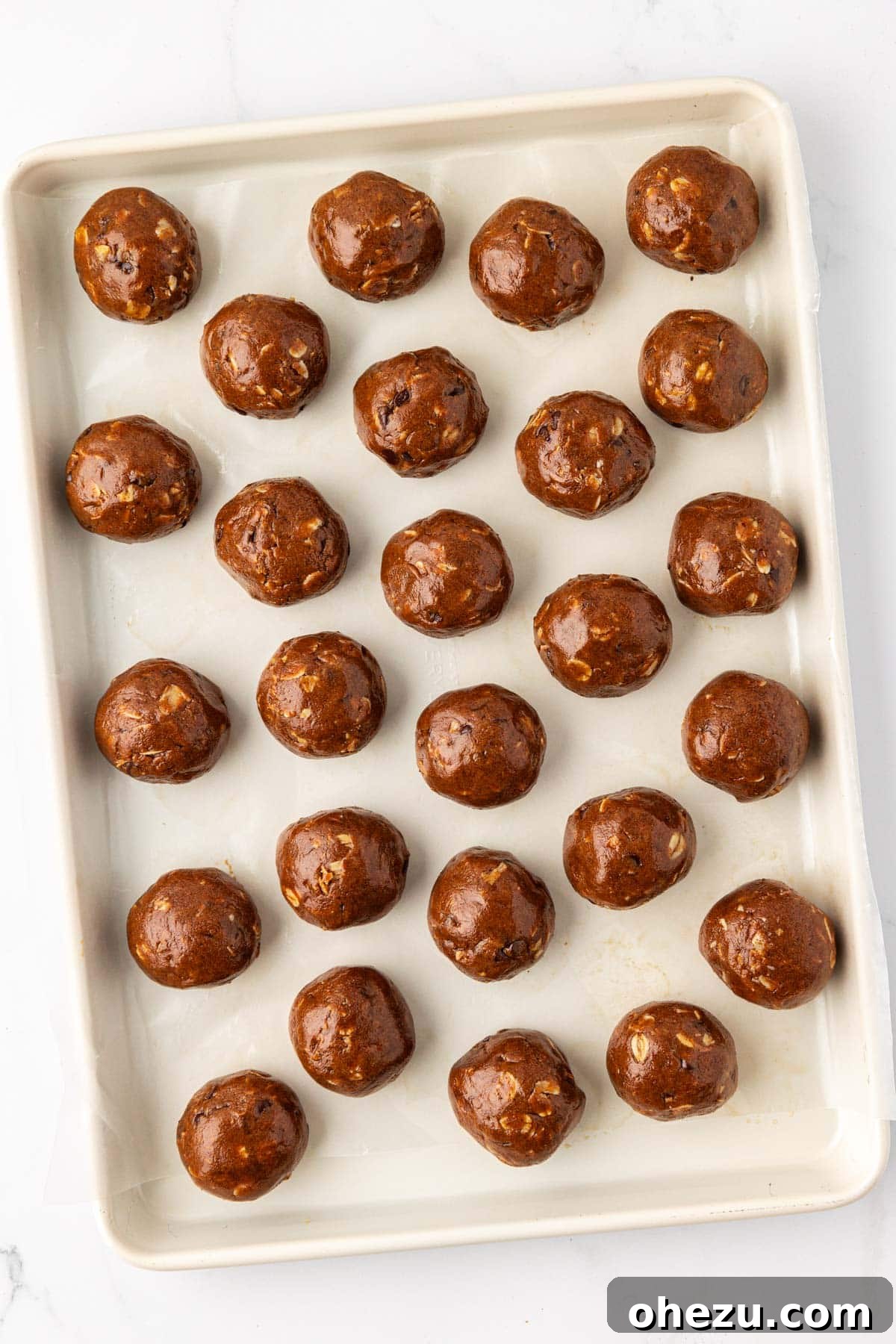 Espresso Energy Bites, perfectly rolled and arranged on a baking sheet lined with wax paper.