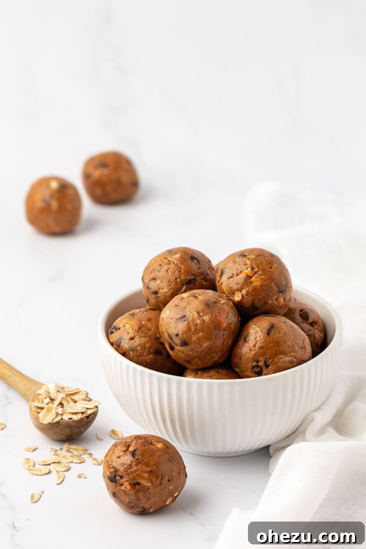 Close-up of freshly rolled peanut butter pretzel energy bites on a baking sheet lined with wax paper