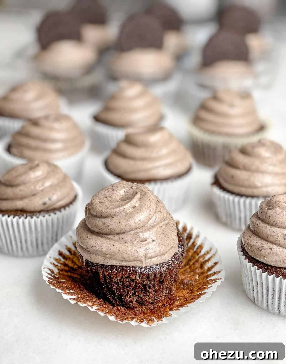 Triple Oreo Chocolate Cupcakes artfully arranged, highlighting the Oreo topping.
