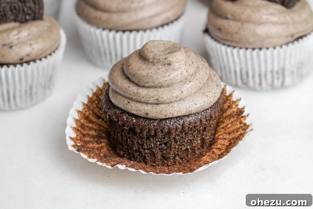 Close-up of a beautifully piped Triple Oreo Chocolate Cupcake, ready to be enjoyed.