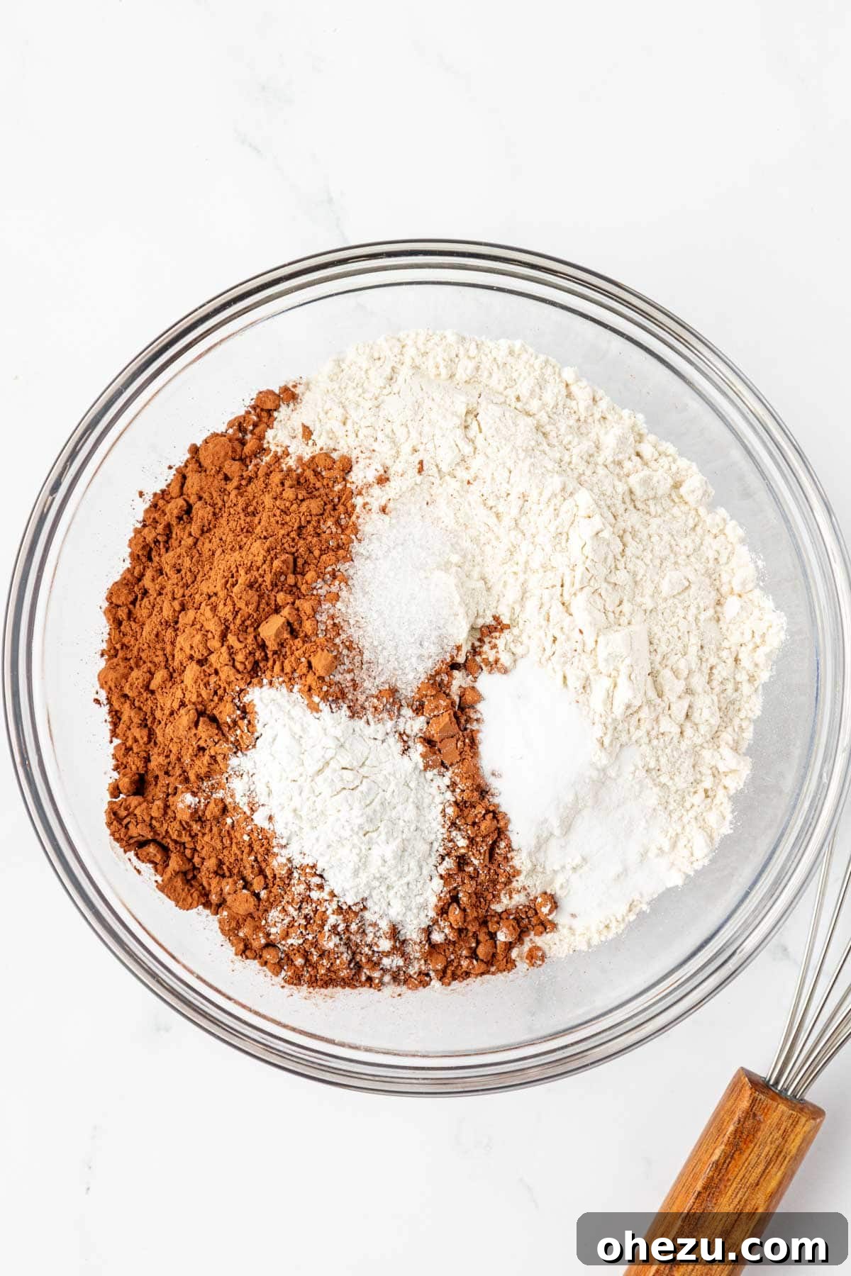 Dry ingredients for chocolate snack cake in a mixing bowl