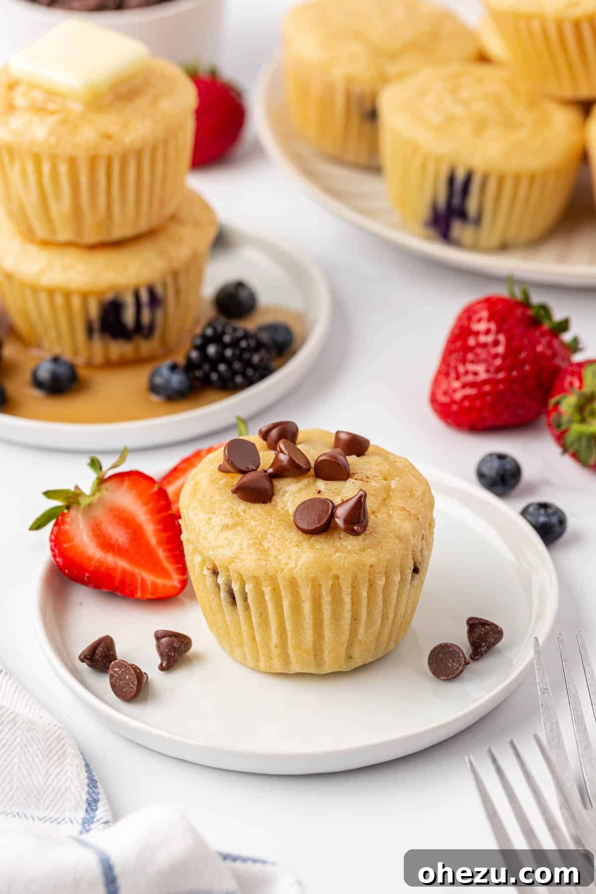 A chocolate chip pancake muffin served on a white plate, ready to be enjoyed as a quick breakfast.
