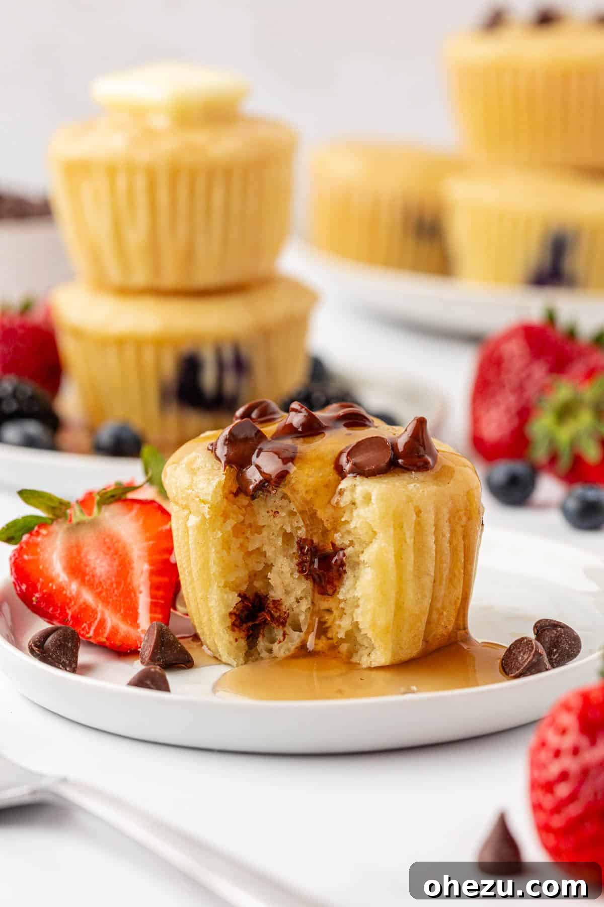 A close-up of a pancake muffin with maple syrup slowly dripping down its side, highlighting its moist texture.