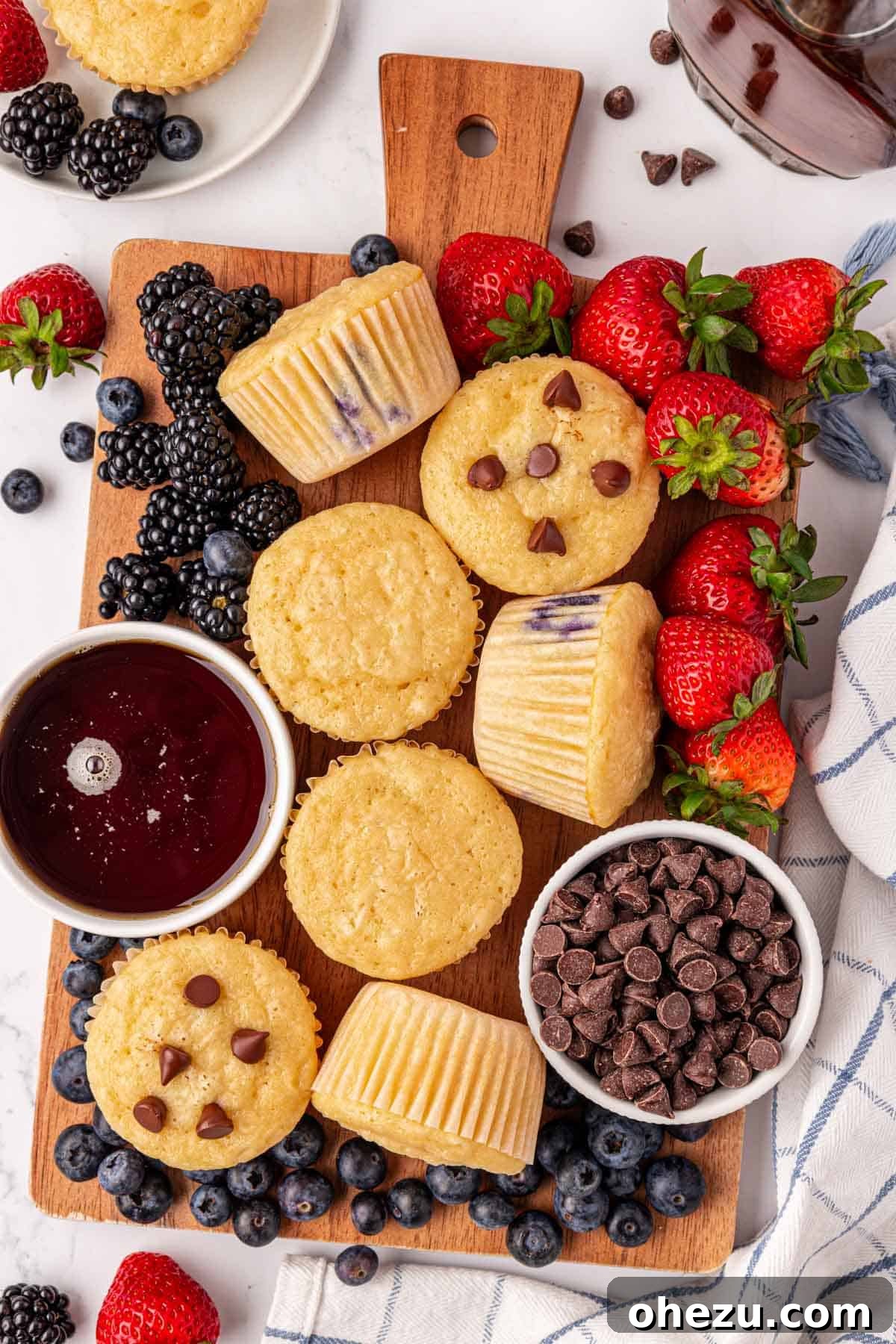 A tray of freshly baked pancake muffins cooling on a wire rack, showcasing their fluffy texture and golden-brown tops.