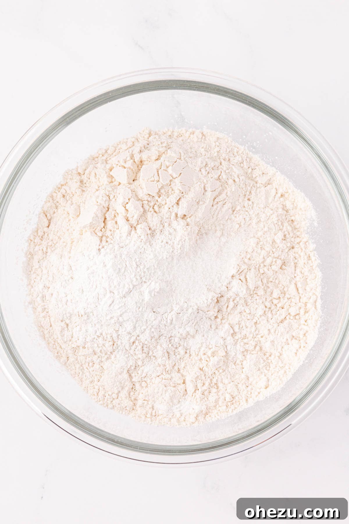 Dry ingredients including flour, baking powder, and salt in a mixing bowl.