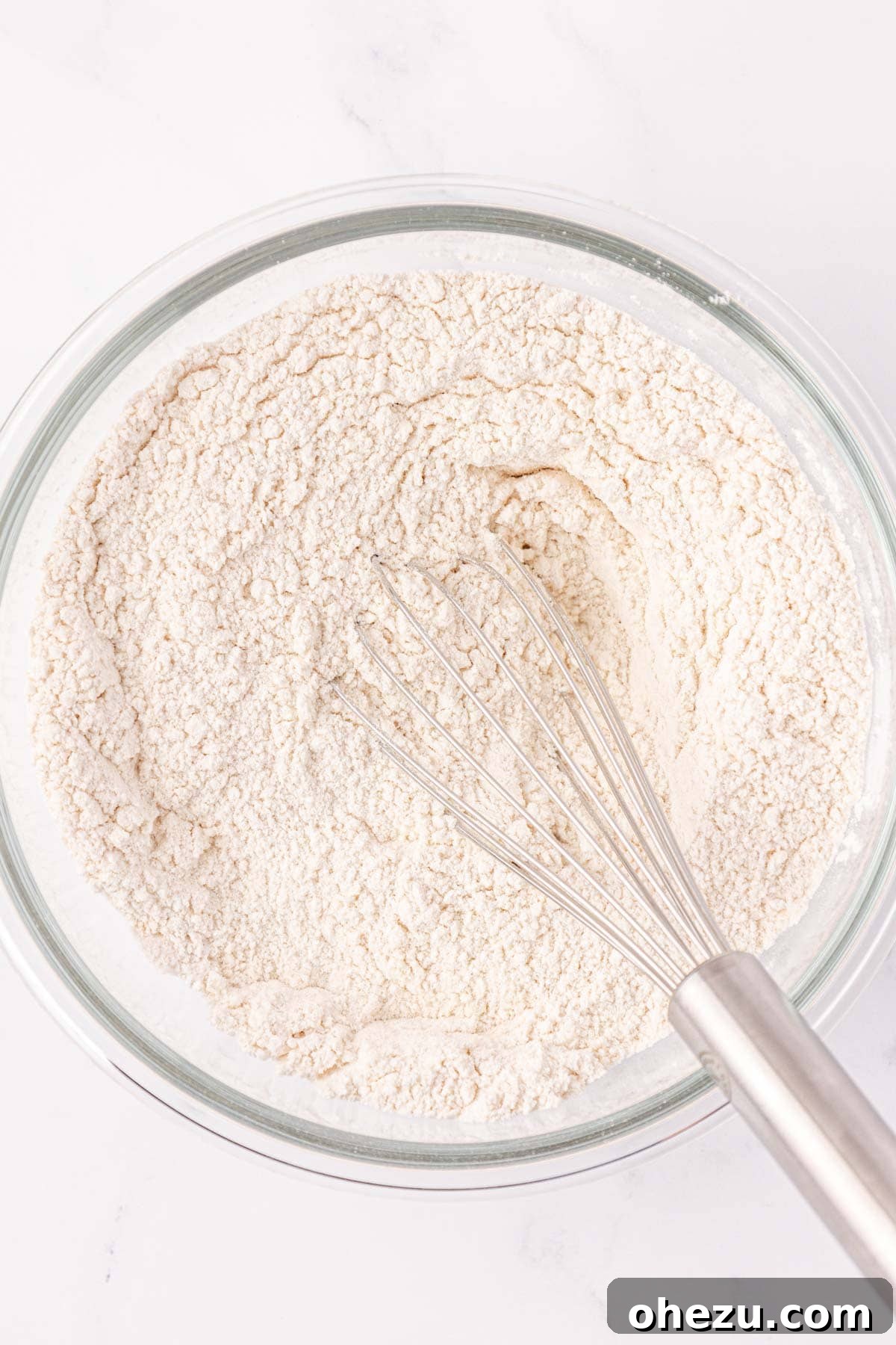 Dry ingredients for pancake muffins after being whisked together in a bowl.