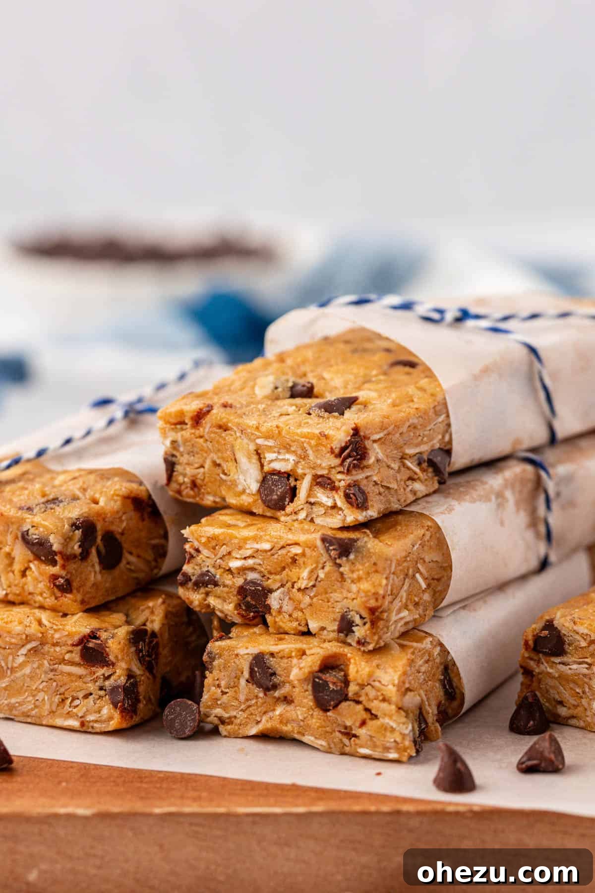 Delicious homemade protein granola bars arranged on a white surface, showcasing their chewy texture and embedded chocolate chips.