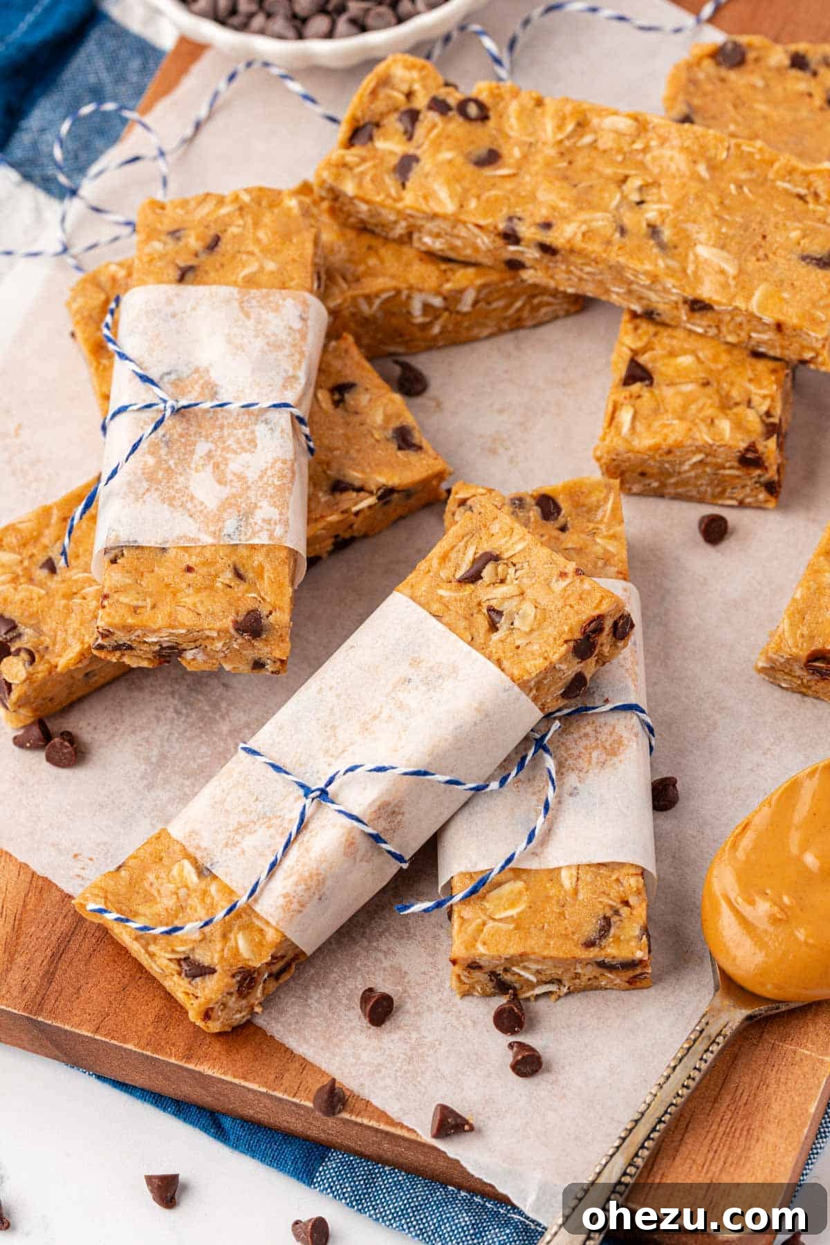 A stack of three neatly cut protein granola bars, emphasizing their consistent size, appealing texture, and visible inclusions like oats and chocolate chips.