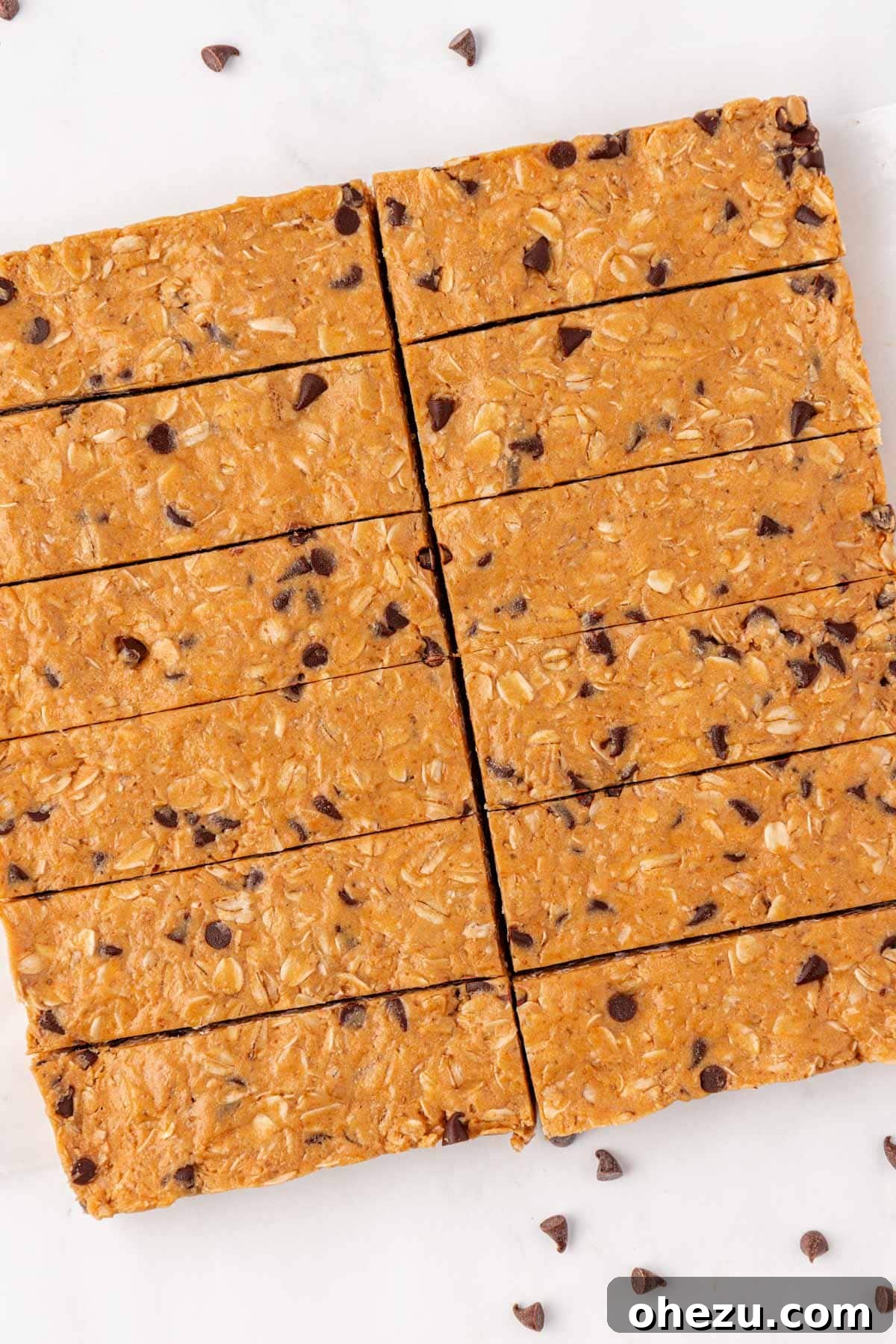 A perfectly cut batch of protein granola bars arranged neatly on a cutting board, showcasing their uniform rectangular shapes and ready for consumption or storage.