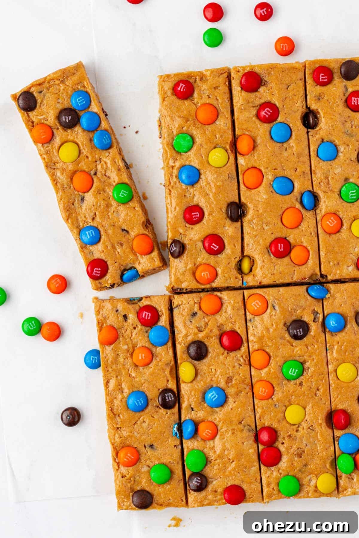 Delicious no-bake monster cookie protein bars stacked on parchment paper