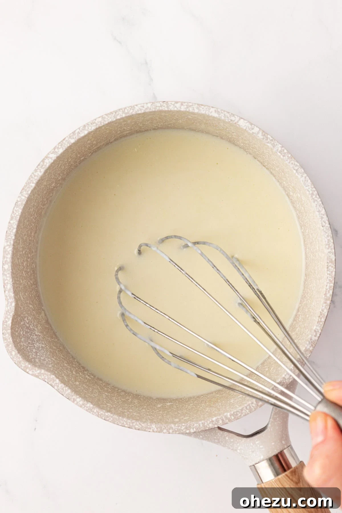 whisking the milk in
