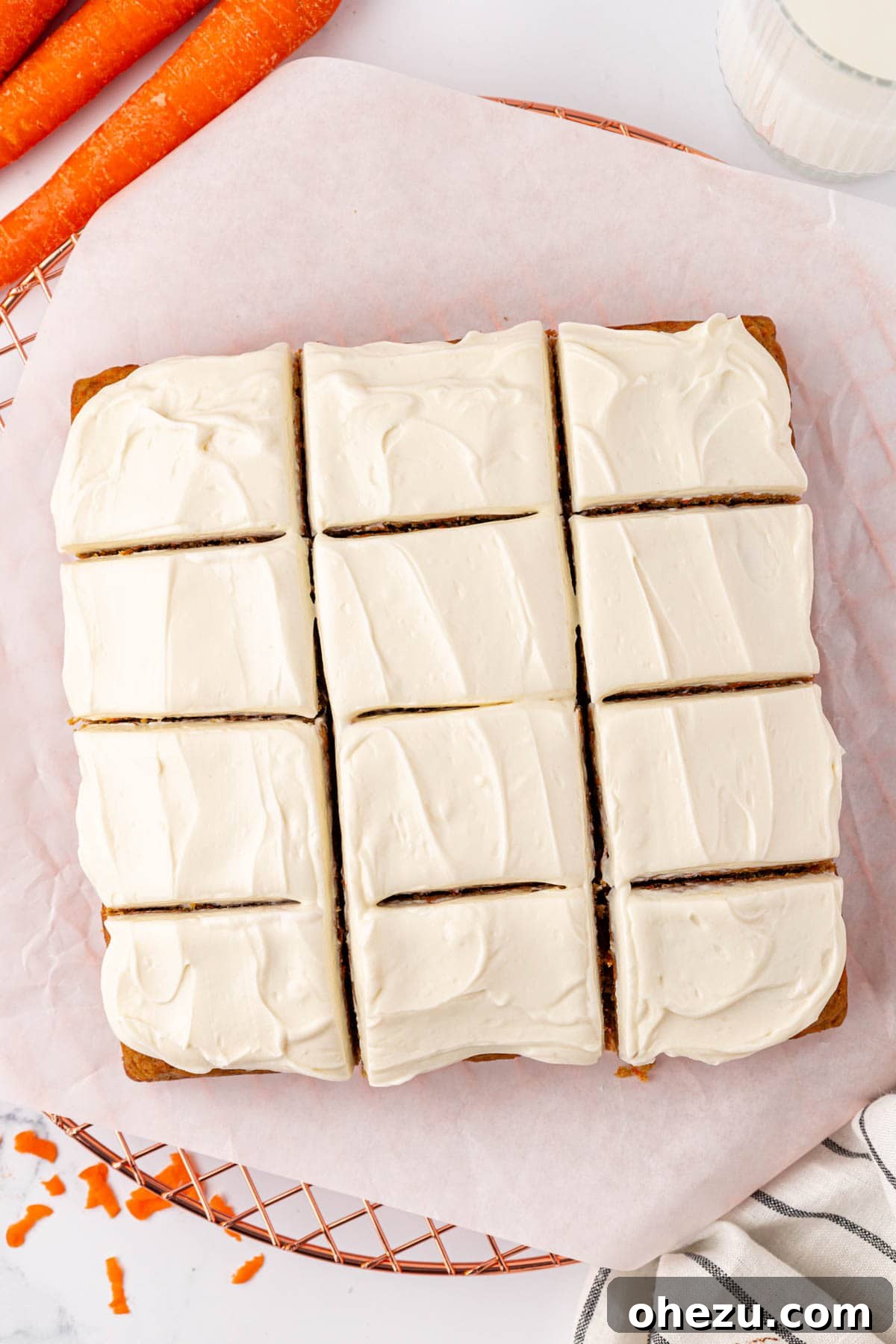 Carrot cake snack bars neatly cut into 12 individual squares in the baking pan.