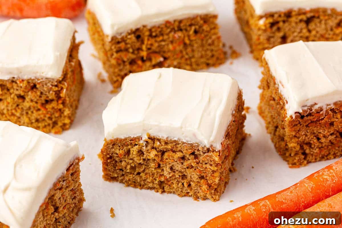 A large batch of carrot cake snack bars on a cooling rack, freshly baked.