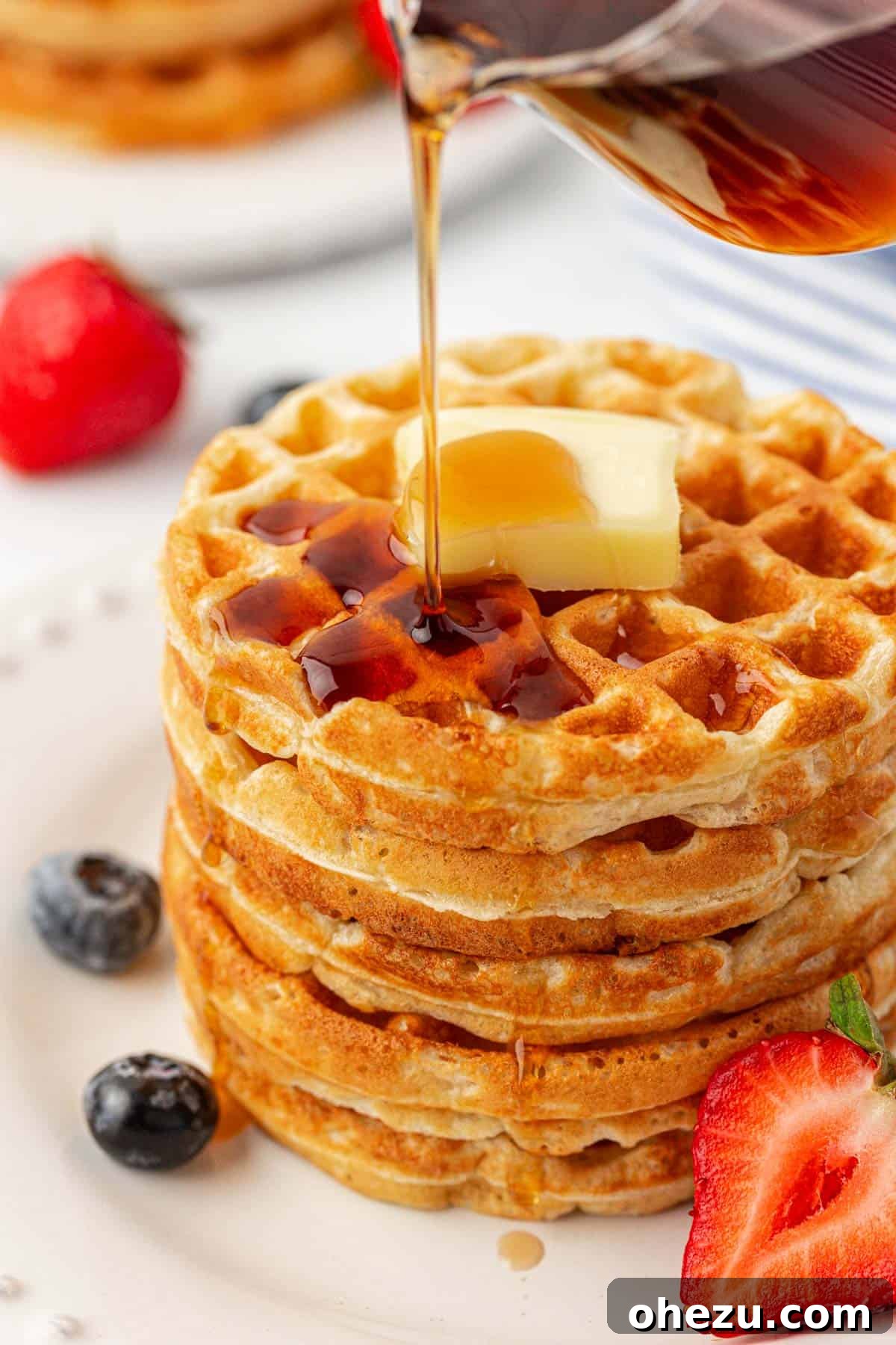 Protein-Packed Greek Yogurt Waffles 16 A stack of golden brown Greek yogurt waffles on a white plate