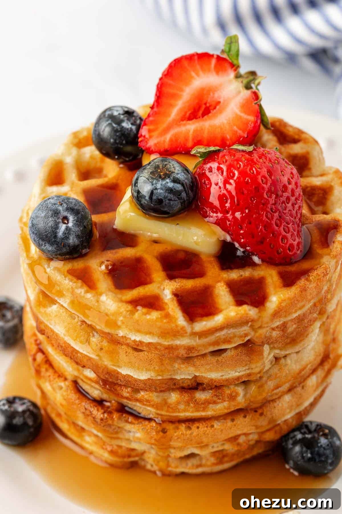 Protein-Packed Greek Yogurt Waffles 20 A vibrant platter of Greek yogurt waffles adorned with fresh fruit, syrup, and butter