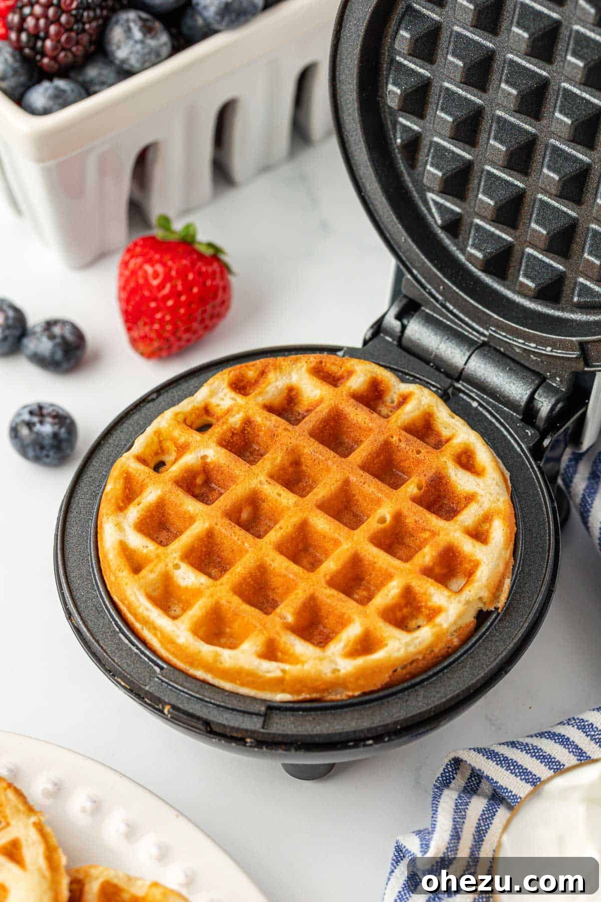 Protein-Packed Greek Yogurt Waffles 4 A freshly cooked Greek yogurt waffle nestled inside a mini waffle maker