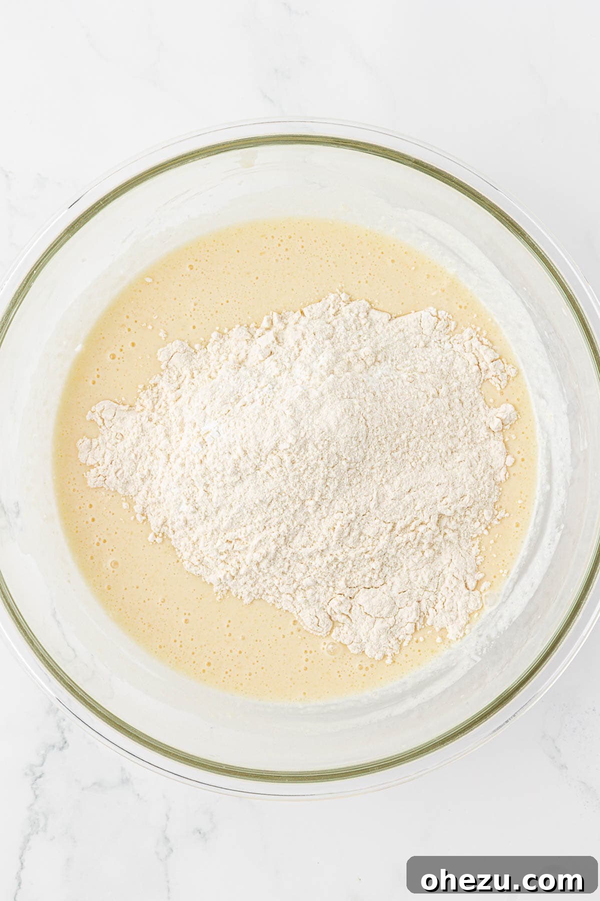 Protein-Packed Greek Yogurt Waffles 10 Adding dry ingredients into the bowl of wet ingredients for waffle batter