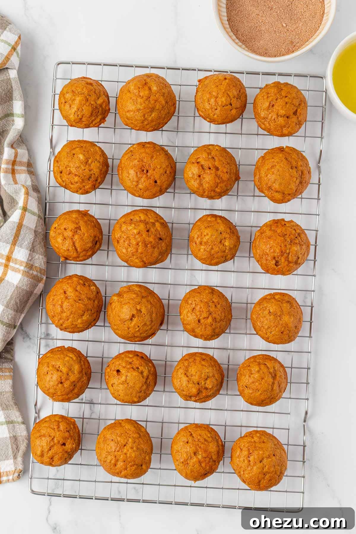 Spiced Pumpkin Donut Bites 15 Freshly baked pumpkin donut mini muffins cooling on a wire rack