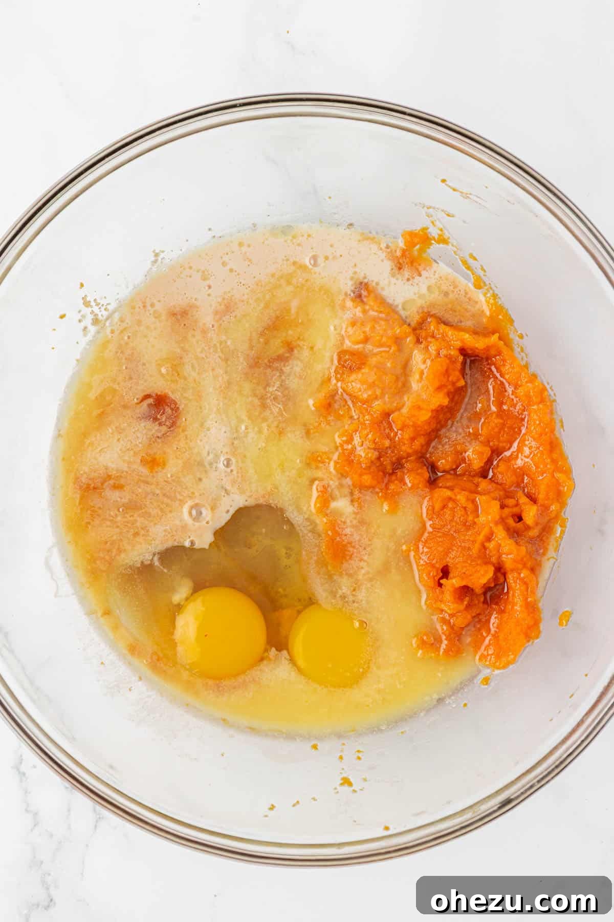 Spiced Pumpkin Donut Bites 7 Various wet ingredients for pumpkin muffins in a mixing bowl