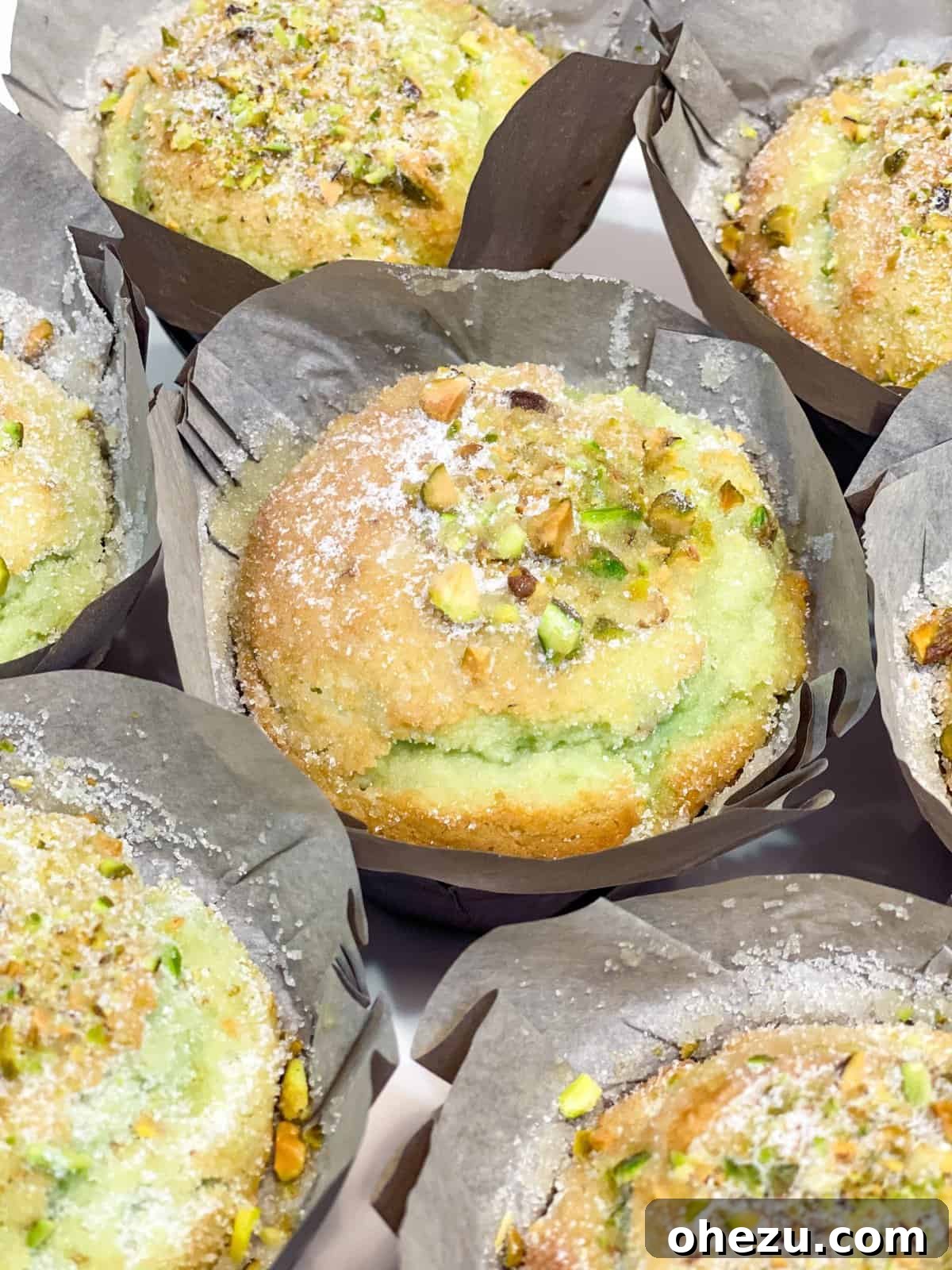 A warm, buttery bakery style pistachio muffin with a crunchy topping
