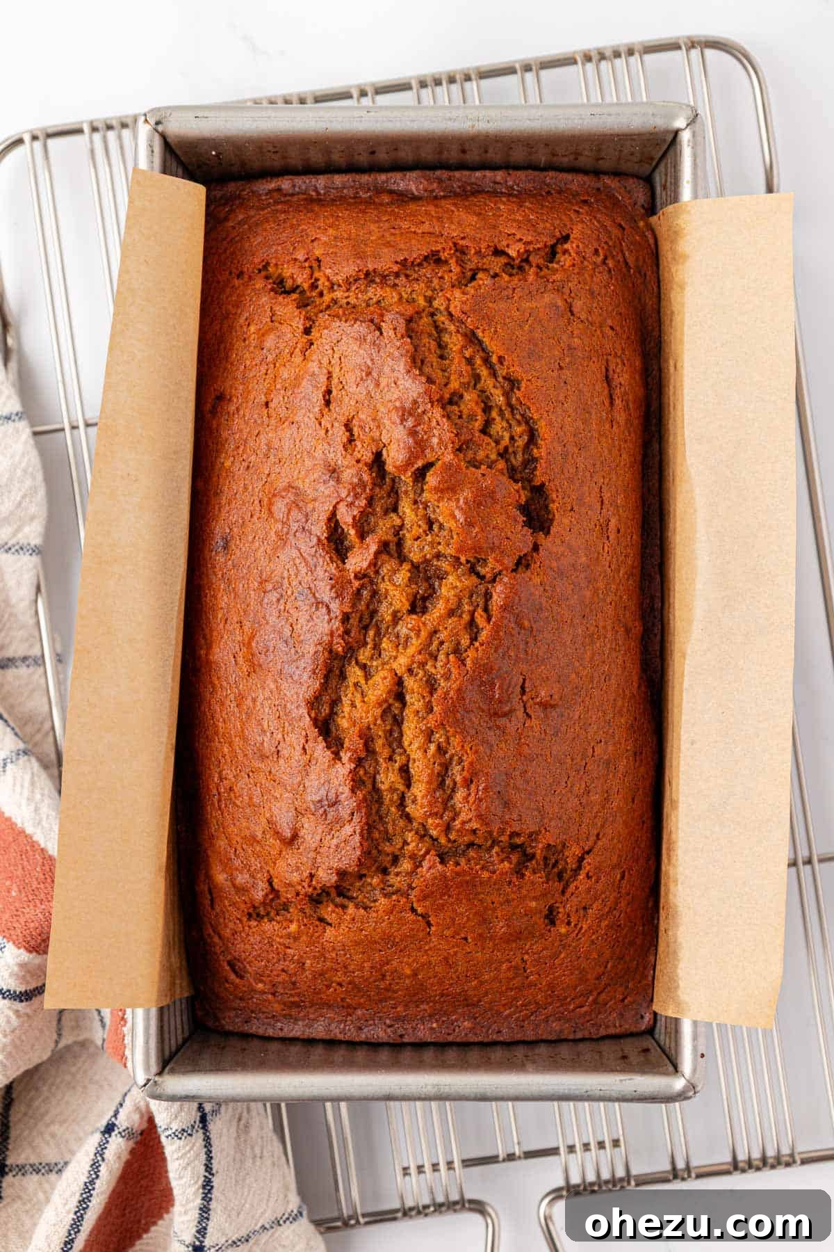 a loaf pan filled with pumpkin bread batter, ready for baking