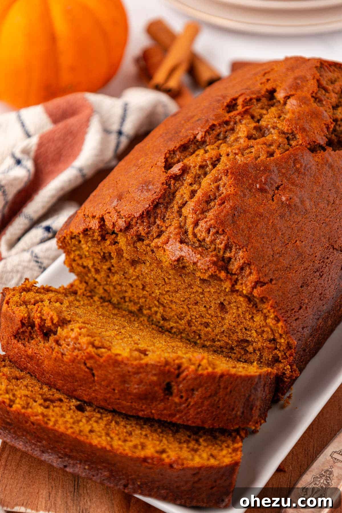 a whole pumpkin bread loaf on a wire cooling rack, viewed from above