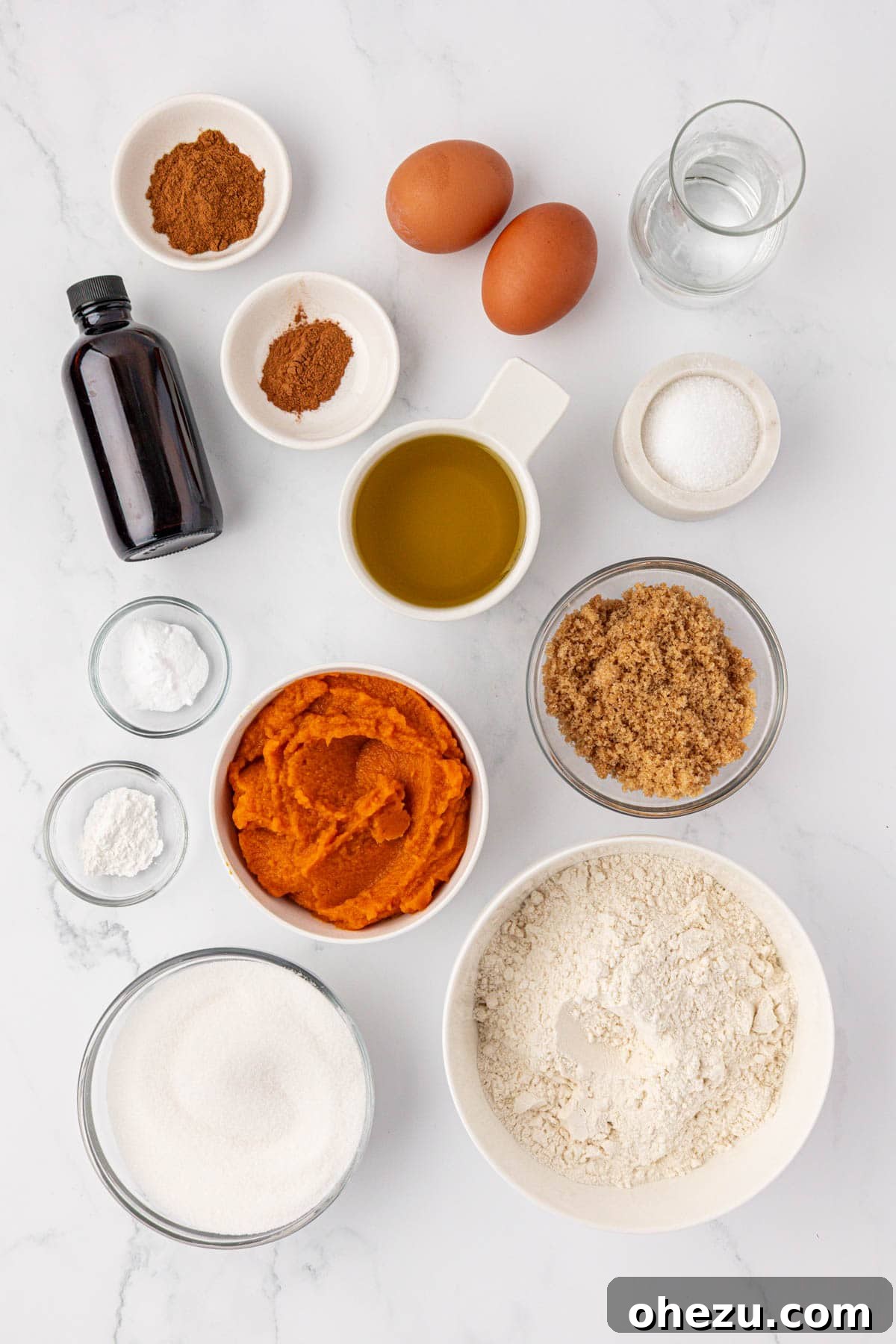 various ingredients laid out on a kitchen counter to make pumpkin bread